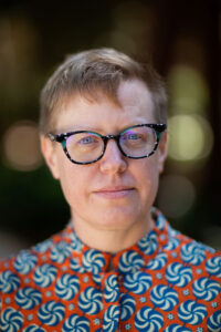 white person with short hair and glasses